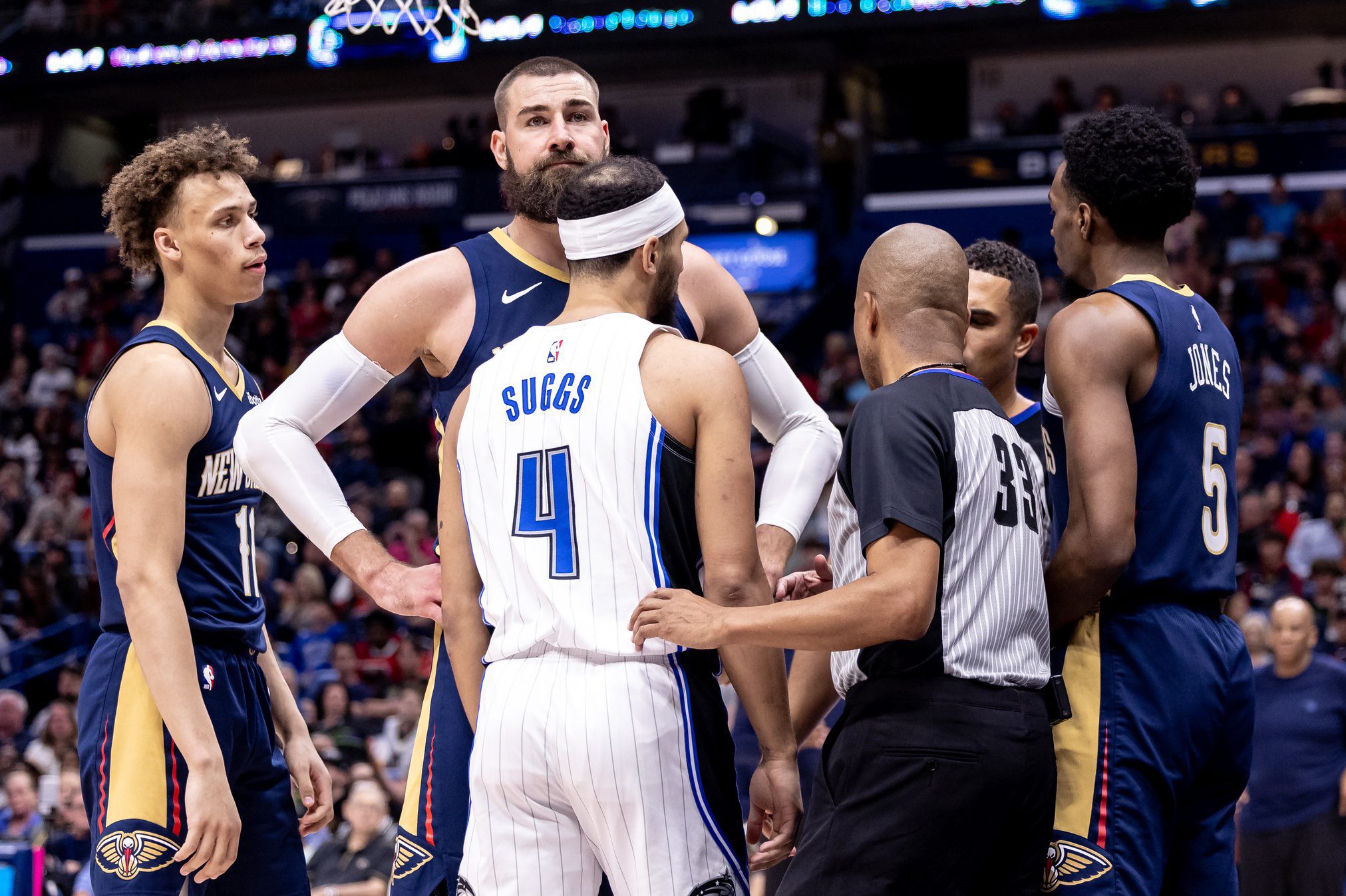 Apr 3, 2024; New Orleans, Louisiana, USA; New Orleans Pelicans center Jonas Valanciunas (17) stands between forward Herbert Jones (5) and Orlando Magic guard Jalen Suggs (4) after a play during the first half at Smoothie King Center. Mandatory Credit: Stephen Lew-USA TODAY Sports