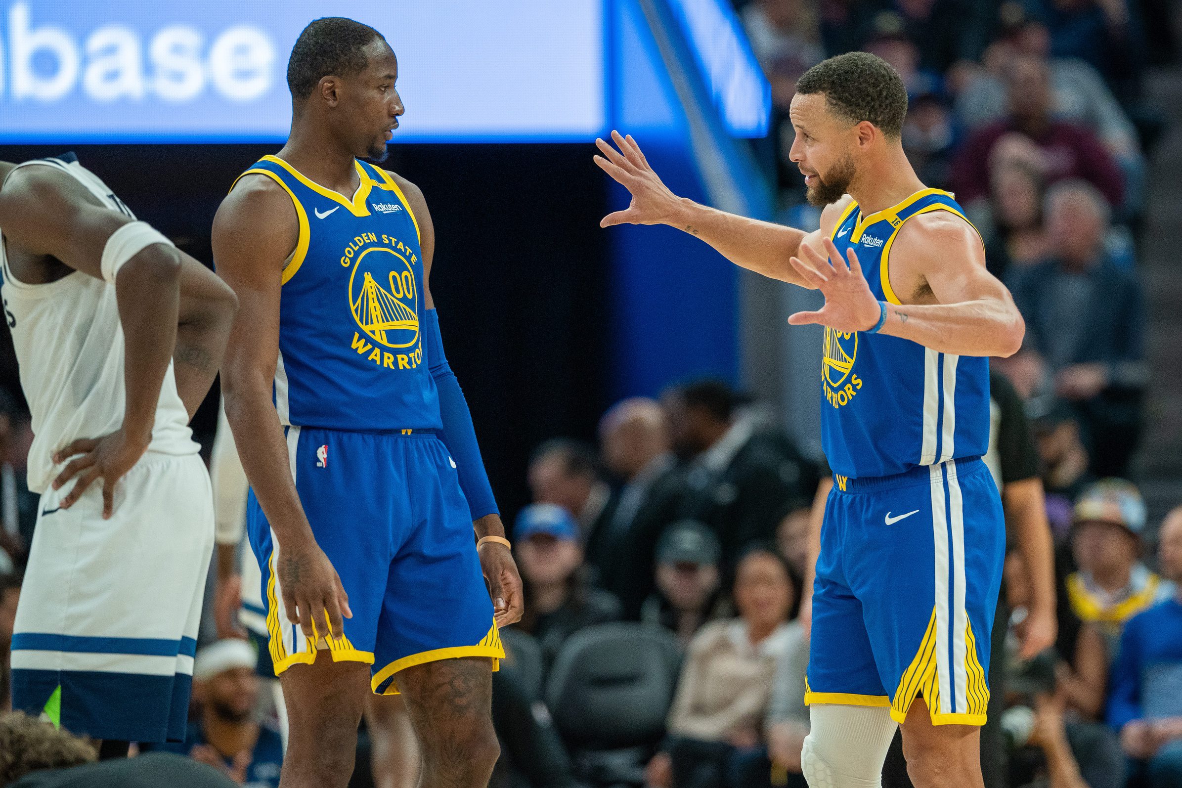 Dec 6, 2024; San Francisco, California, USA; Golden State Warriors guard Stephen Curry (30) speaks with forward Jonathan Kuminga (00) during a time out against the Minnesota Timberwolves during the fourth quarter at Chase Center.