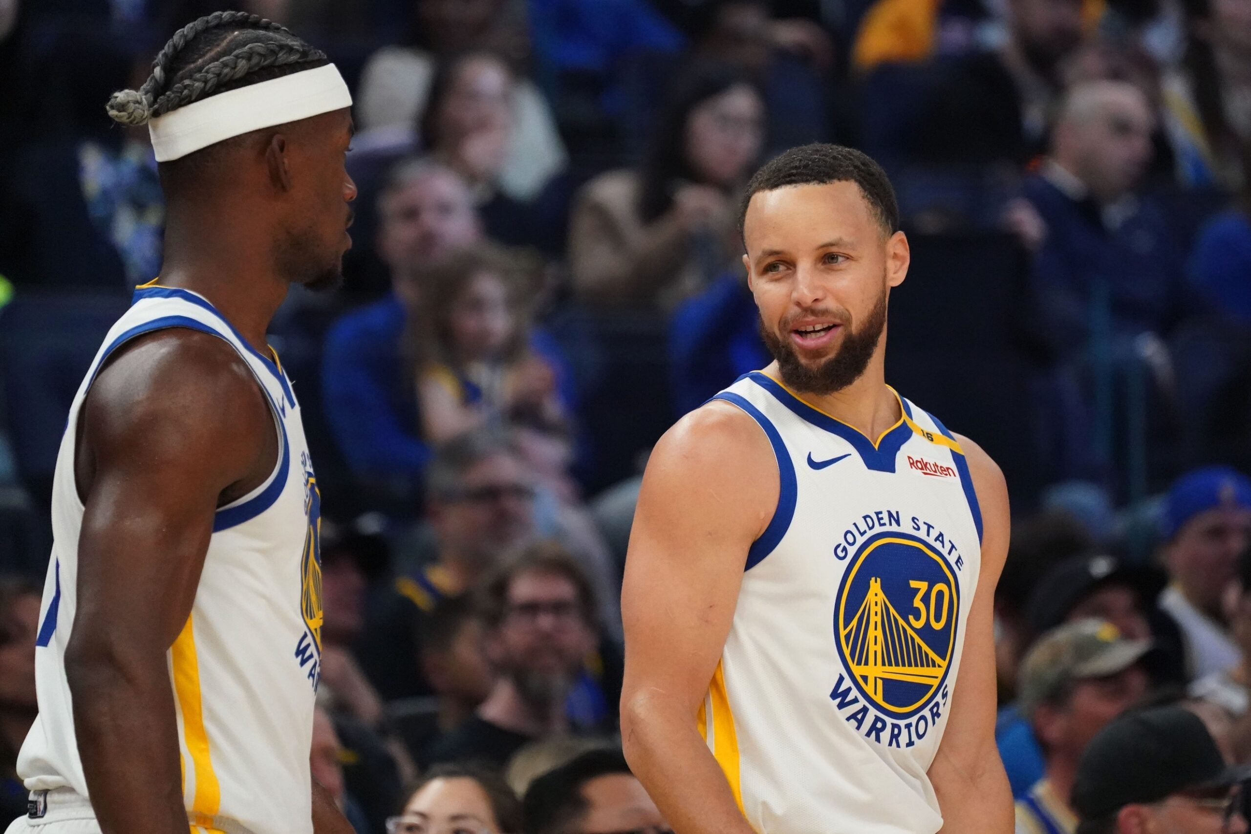 Golden State Warriors guard Stephen Curry (30) talks with forward Jimmy Butler III (10) vs. the Detroit Pistons in the first quarter at Chase Center.
