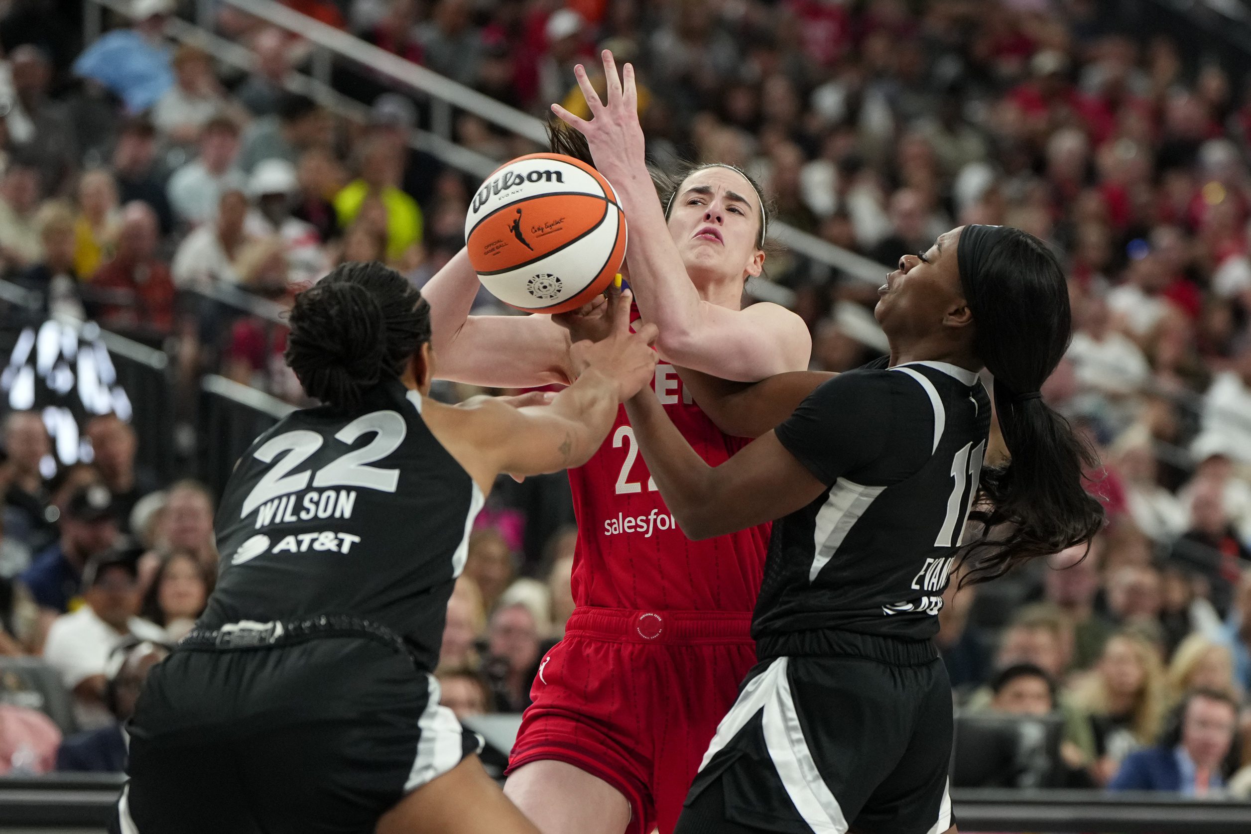 Indiana Fever guard Caitlin Clark (22) is defended by Las Vegas Aces center A'ja Wilson (2