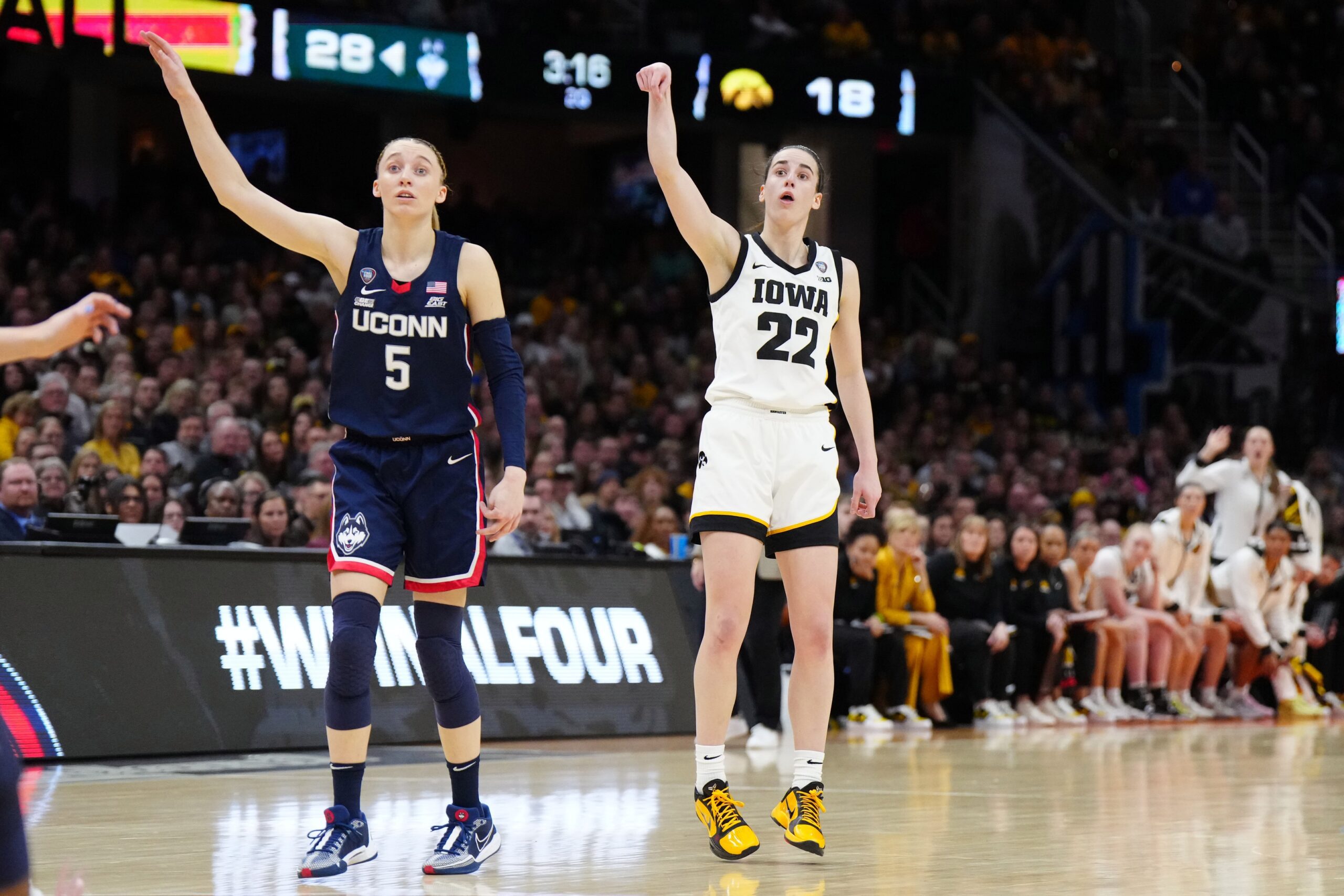 Apr 5, 2024; Cleveland, OH, USA; Iowa Hawkeyes guard Caitlin Clark (22) and Connecticut Huskies guard Paige Bueckers (5) react in the second quarter in the semifinals of the Final Four of the womens 2024 NCAA Tournament at Rocket Mortgage FieldHouse. Mandatory Credit: Kirby Lee-Imagn Images
