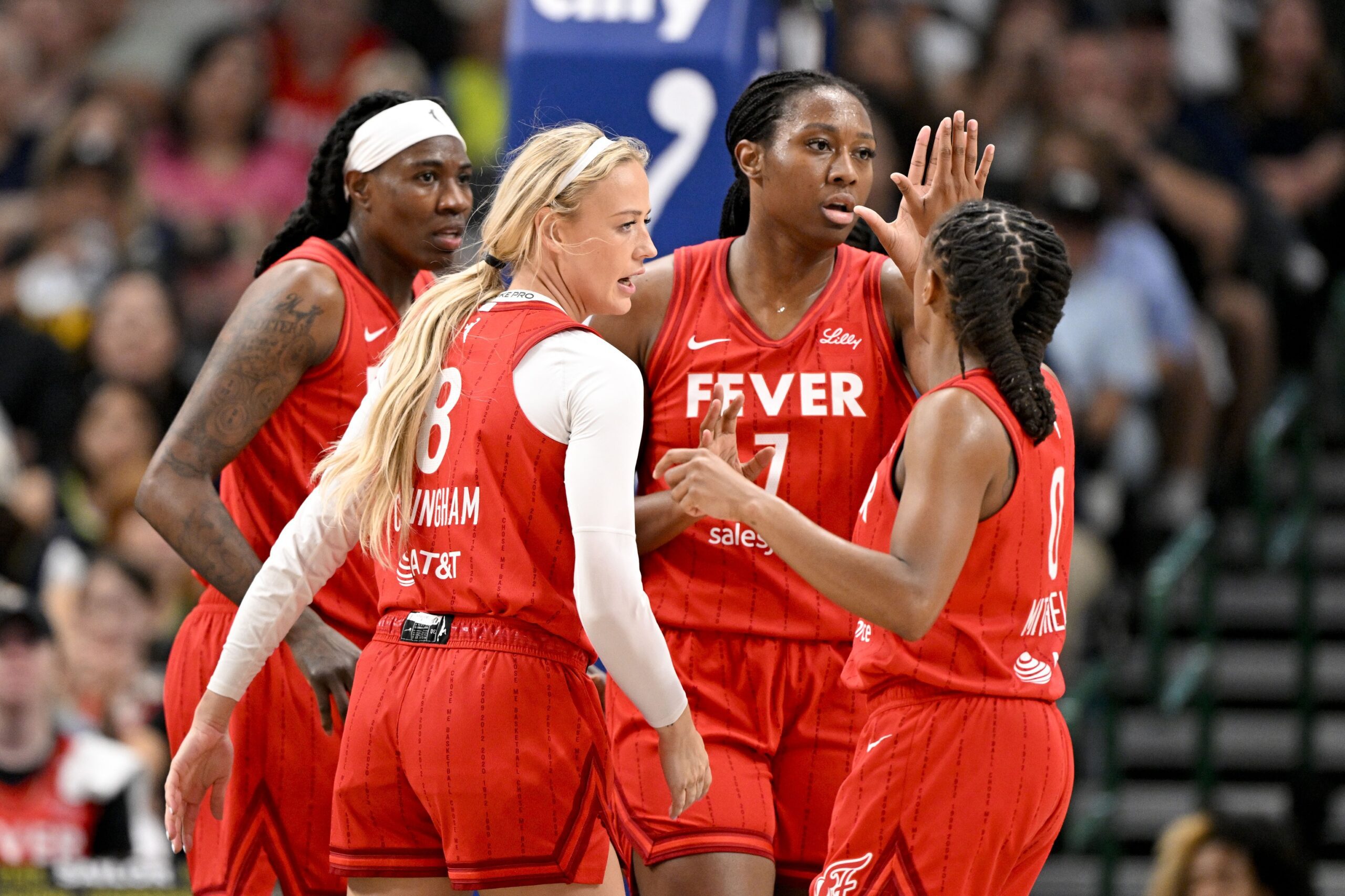 Jun 27, 2025; Dallas, Texas, USA; Indiana Fever guard Sophie Cunningham (8) and forward Aliyah Boston (7) and guard Kelsey Mitchell (0) celebrate during the first quarter against the Dallas Wings at the American Airlines Center. Mandatory Credit: Jerome Miron-Imagn Images