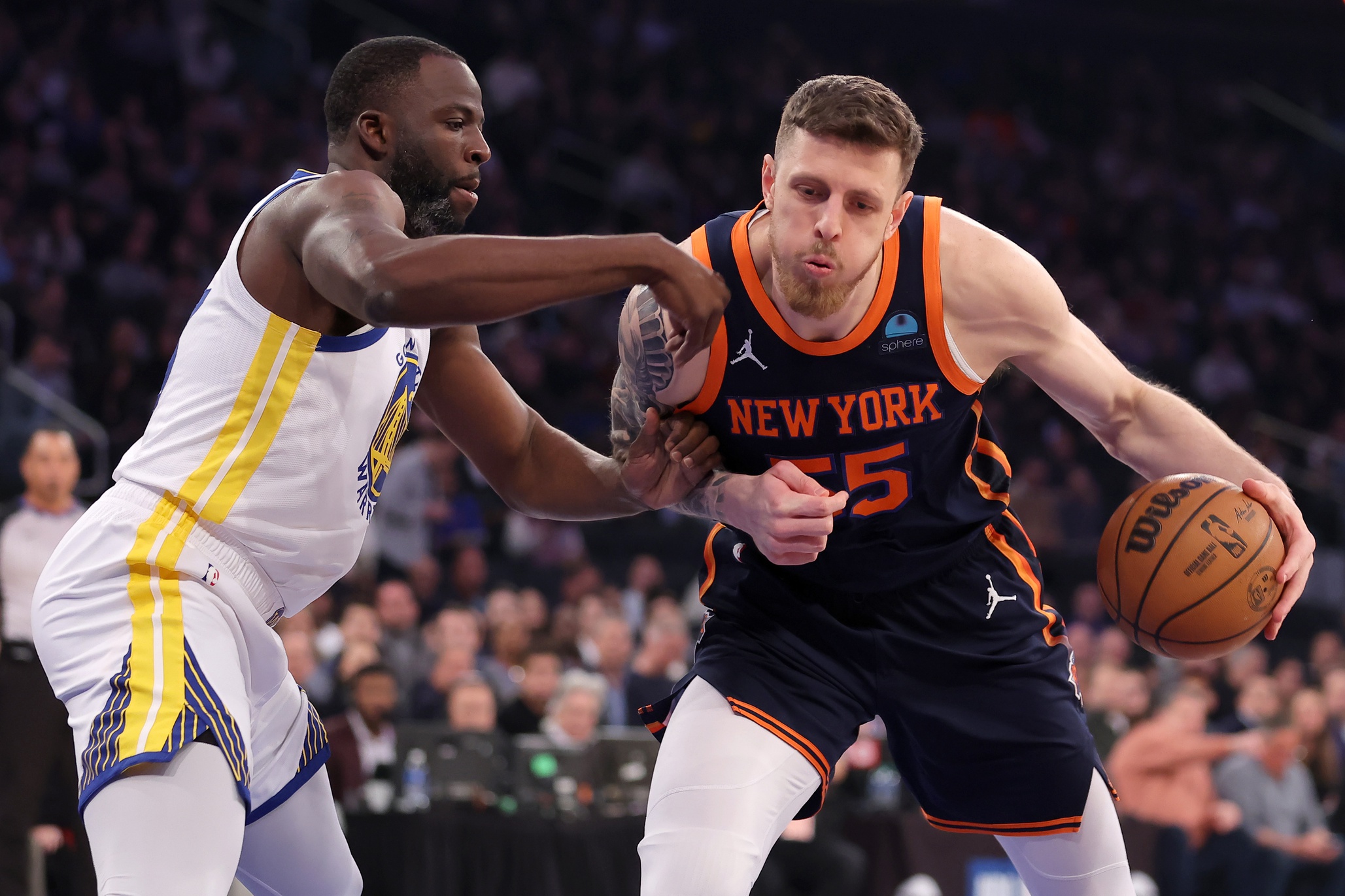 Feb 29, 2024; New York, New York, USA; New York Knicks center Isaiah Hartenstein (55) controls the ball against Golden State Warriors forward Draymond Green (23) during the first quarter at Madison Square Garden. Mandatory Credit: Brad Penner-USA TODAY Sports
