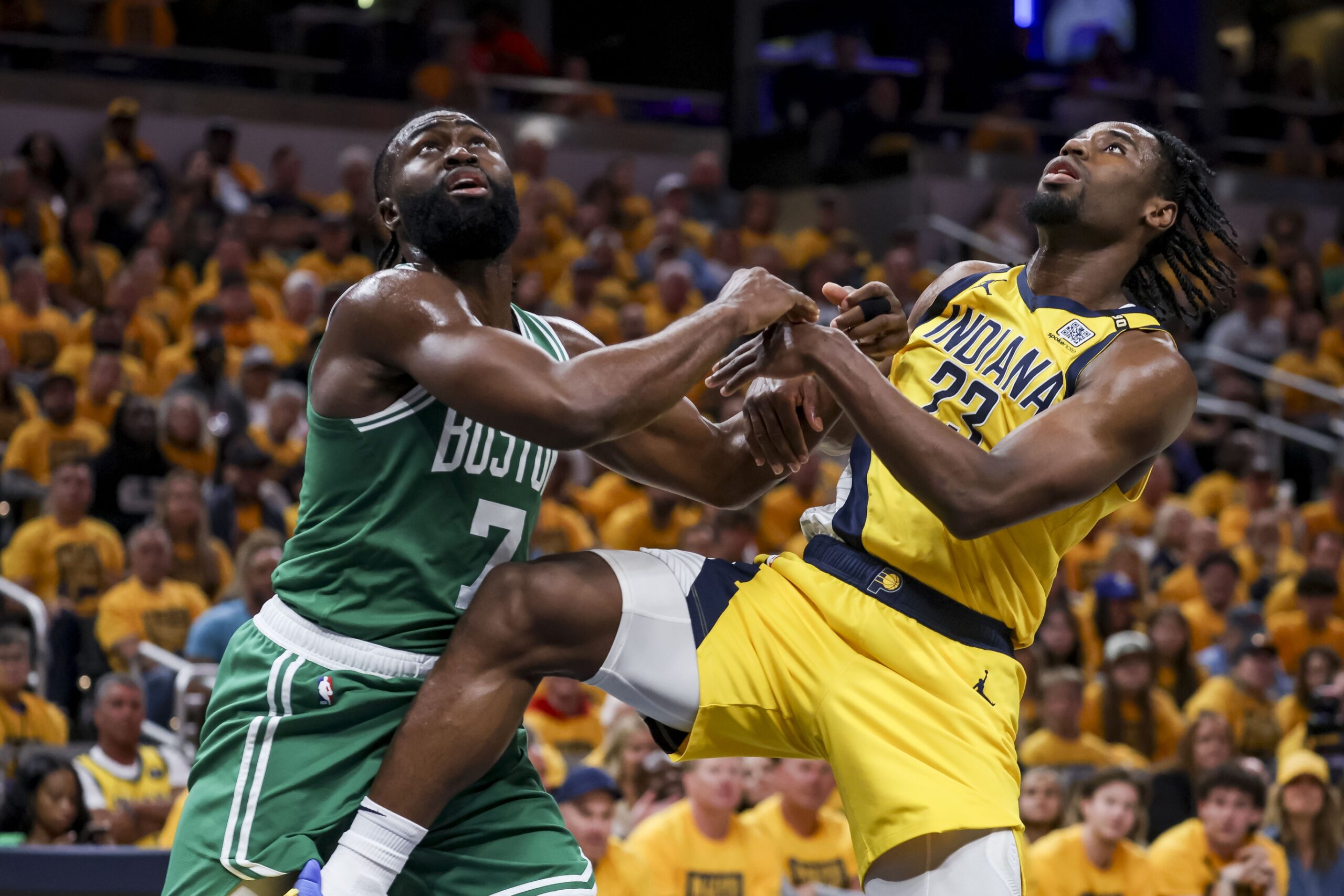 May 27, 2024; Indianapolis, Indiana, USA; Boston Celtics guard Jaylen Brown (7) and Indiana Pacers forward Aaron Nesmith (23) push each other away to intercept the ball during the second quarter during game four of the eastern conference finals for the 2024 NBA playoffs at Gainbridge Fieldhouse. Mandatory Credit: Trevor Ruszkowski-USA TODAY Sports