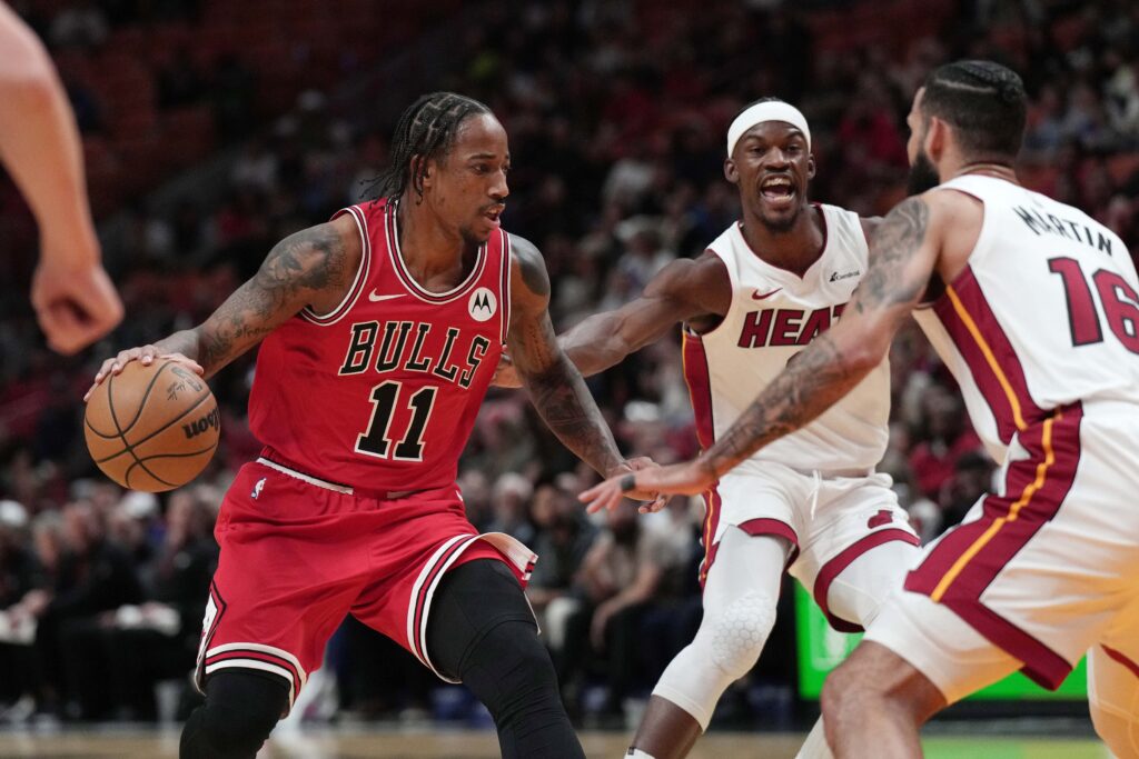 Dec 14, 2023; Miami, Florida, USA; Chicago Bulls forward DeMar DeRozan (11) drives toward the basket as Miami Heat forward Caleb Martin (16) defends during the first half at Kaseya Center. Mandatory Credit: Jim Rassol-USA TODAY Sports