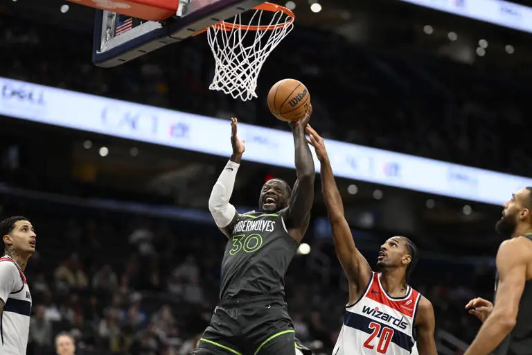 Timberwolves Grind Out Win vs Wizards 120-106 1 Minnesota Timberwolves forward Julius Randle (30) goes to the basket as he is fouled by Washington Wizards forward Alex Sarr (20) during the first half of an NBA basketball game, Monday, Jan. 13, 2025, in Washington. (AP Photo/Nick Wass)