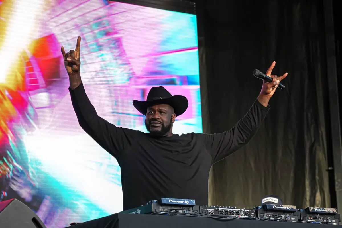 Shaquille O'Neal holds up the sign of the horns during a DJ performance ahead of the College Football Playoff semifinal game between the Texas Longhorns and Ohio State in the Cotton Bowl at AT&T Stadium on Friday, Jan. 10, 2024 in Arlington, Texas.