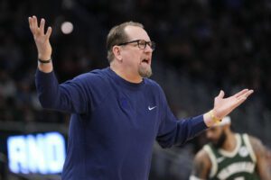 Feb 9, 2025; Milwaukee, Wisconsin, USA; Milwaukee Bucks guard Damian Lillard (0) drives for the basket against Philadelphia 76ers center Joel Embiid (21) during the third quarter at Fiserv Forum. Mandatory Credit: Jeff Hanisch-Imagn Images