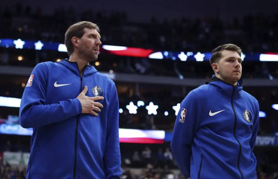 Dallas Mavericks forward Dirk Nowitzki (left) and forward Luka Doncic (right) during the national anthem before the game against the Minnesota Timberwolves at American Airlines Center.