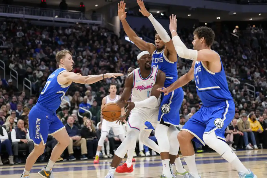 Miami Heat center Bam Adebayo (13) looks tp pass the ball under pressure from Milwaukee Bucks guard AJ Green (20), forward Giannis Antetokounmpo (34) and jcenter Brook Lopez (11) during the third quarter at Fiserv Forum.