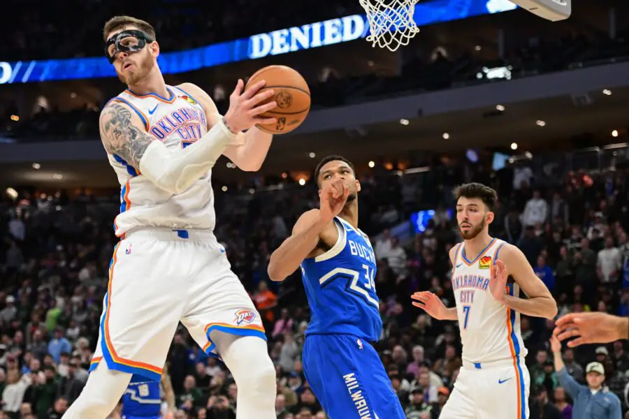 Milwaukee Bucks forward Giannis Antetokounmpo (34) passes the ball away from Oklahoma City Thunder center Isaiah Hartenstein (55) in the fourth quarter at Fiserv Forum.