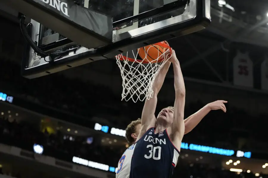 Mar 23, 2025; Raleigh, NC, USA; Connecticut Huskies forward Liam McNeeley (30) drives to the basket as Florida Gators center Micah Handlogten (3) defends during the second half in the second round of the NCAA Tournament at Lenovo Center. Mandatory Credit: Bob Donnan-Imagn ImagesUconn