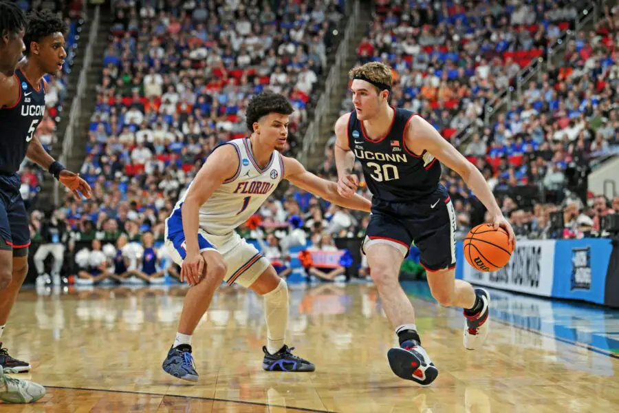 Mar 23, 2025; Raleigh, NC, USA; Connecticut Huskies forward Liam McNeeley (30) drives to the basket during the second half against Florida Gators guard Walter Clayton Jr. (1) in the second round of the NCAA Tournament at Lenovo Center. Mandatory Credit: Zachary Taft-Imagn Images Uconn