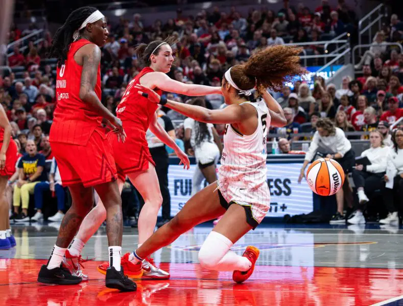 'I Got It': Caitlin Clark Offers To Pay Teammate's 'Hefty' WNBA Fine For Pushing Angel Reese 1 Indiana Fever guard Caitlin Clark (22) fouls Chicago Sky forward Angel Reese (5) in the second half at Gainbridge Fieldhouse.