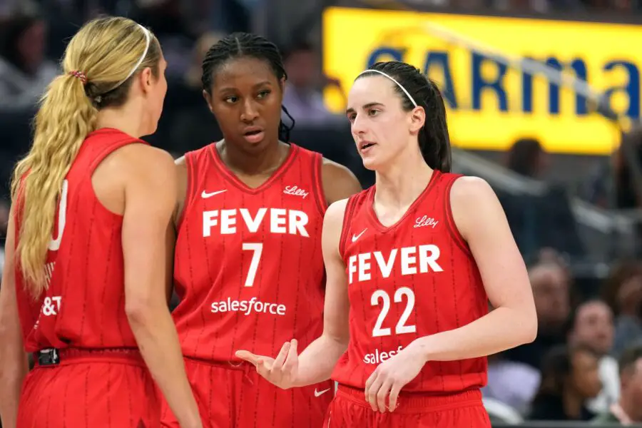 Jun 19, 2025; San Francisco, California, USA; Indiana Fever guard Caitlin Clark (22) talks to guard Lexie Hull (left) and forward Aliyah Boston (7) during the third quarter against the Golden State Valkyries at Chase Center. Mandatory Credit: Darren Yamashita-Imagn Images