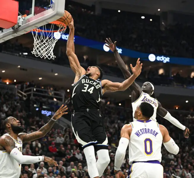Dec 2, 2022; Milwaukee, Wisconsin, USA;  Milwaukee Bucks forward Giannis Antetokounmpo (34) drives to the basket against Los Angeles Lakers forward LeBron James (6), left, and Los Angeles Lakers forward Wenyen Gabriel (35) in the first half at Fiserv Forum. Mandatory Credit: Michael McLoone-USA TODAY Sports
