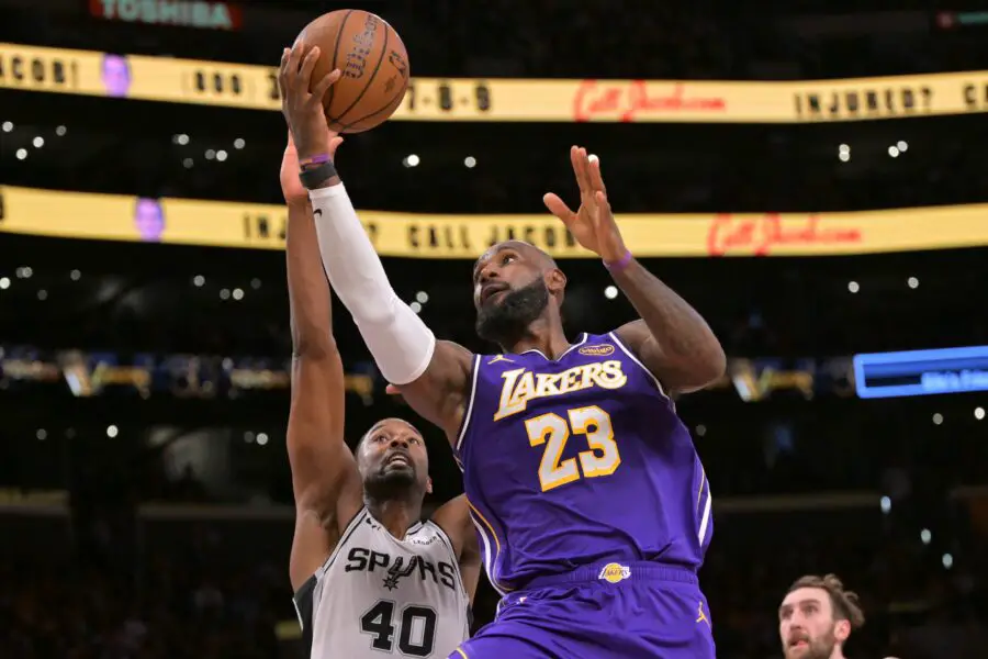 Dec 10, 2025; Los Angeles, California, USA;  Los Angeles Lakers forward Lebron James (23) is defended by San Antonio Spurs forward Harrison Barnes (40) as he drives to the basket during the second half at Crypto.com Arena. Mandatory Credit: Jayne Kamin-Oncea-Imagn Images