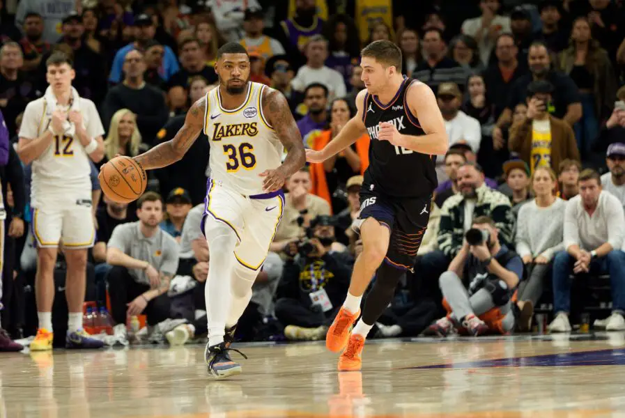 Dec 14, 2025; Phoenix, Arizona, USA; Los Angeles Lakers guard Marcus Smart (36) dribbles the ball against Phoenix Suns guard Collin Gillespie (12) during the second half of play at Mortgage Matchup Center. Mandatory Credit: Allan Henry-Imagn Images