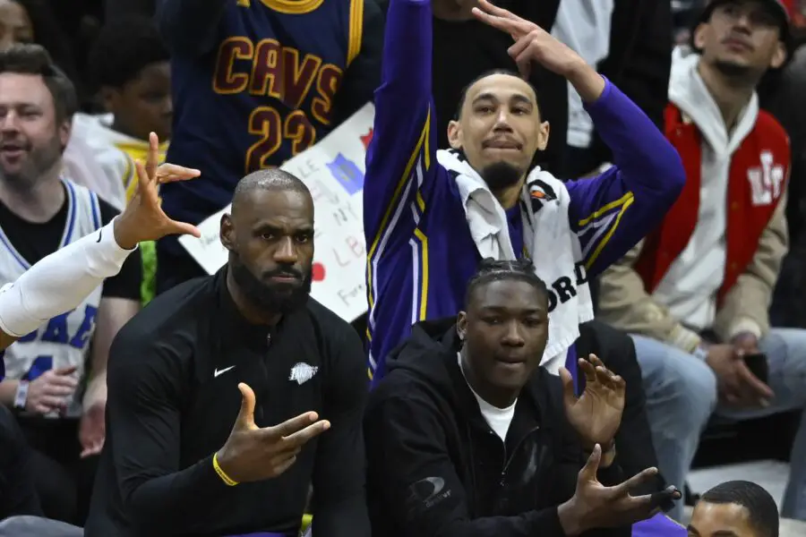 Jan 28, 2026; Cleveland, Ohio, USA; Los Angeles Lakers forward LeBron James (left) reacts after watching his son guard Bronny James (9) make a 3-point basket in the fourth quarter against the Cleveland Cavaliers at Rocket Arena. Mandatory Credit: David Richard-Imagn Images